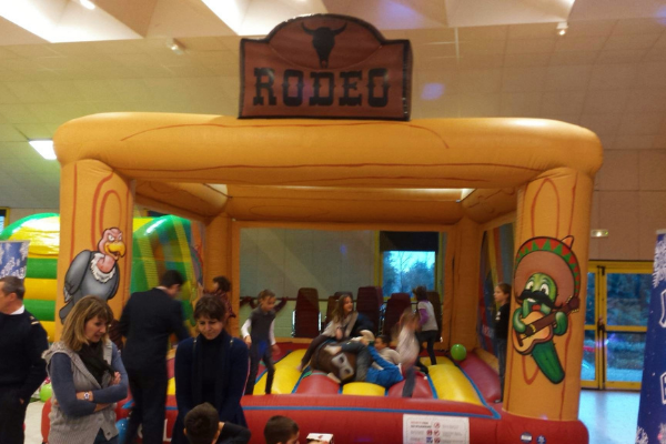 un château gonflable nommé rodeo avec des enfants qui jouent dedans